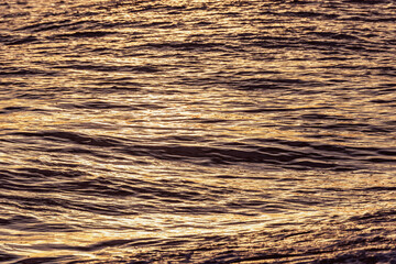 Water surface of the open sea at sunset.