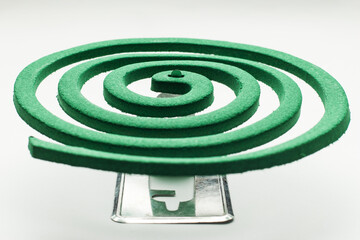 Mosquito repellent incense on a metal stand. Green  spiral, selective focus