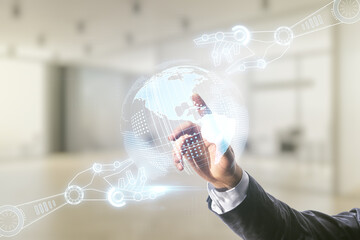 Male hand clicks on abstract virtual robotics technology sketch with globe on blurred office background, future technology and AI concept. Double exposure