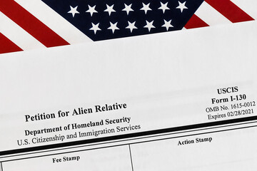 close-up of i-130 form. petition for alien relative topview, on a background of United States flag.