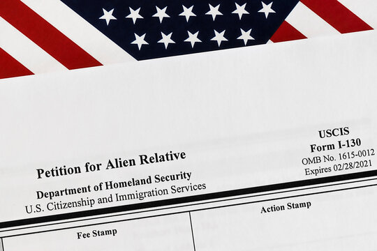 Close-up Of I-130 Form. Petition For Alien Relative Topview, On A Background Of United States Flag.