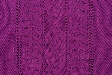 Close Up Of Bright Violet Handmade Knitted Sweater or Scarf. Knitting Background or Wallpaper Template. With Ornaments, Braids and Decoration