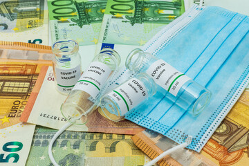 Coronavirus vaccines and surgical mask on euro banknotes