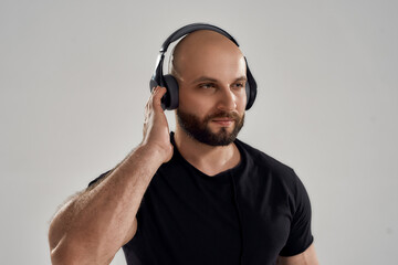Young handsome caucasian bodybuilder listening to music