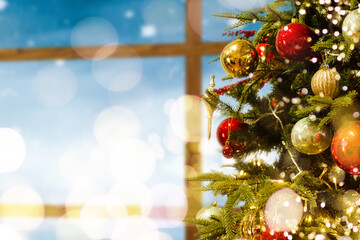 Decorated Christmas tree in gold and purple toys with lights bokeh textured background