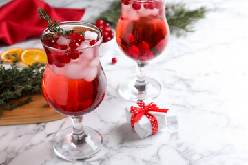 Delicious Christmas liqueur on white marble table, closeup