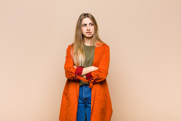 blonde woman doubting or thinking, biting lip and feeling insecure and nervous, looking to copy...