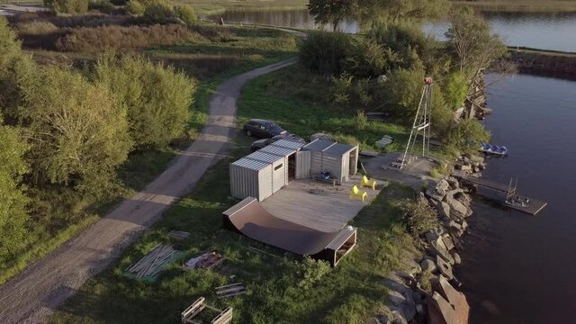 Aerial drone footage of a wakeboard cable park in southern sweden bromölla during a summer evening sunset