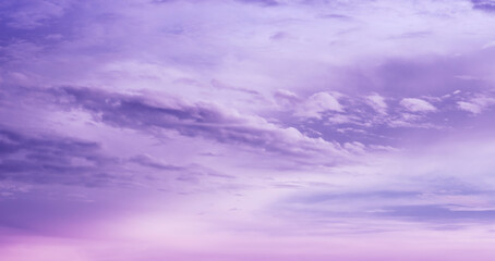 Beautiful purple sky background. Soft white clouds at sunset. Many pink and magenta tones and patterns of clouds