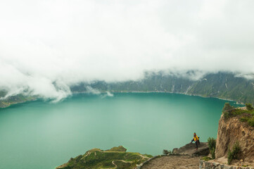 
beautiful panoramic landscape girl in lakeside crater, quilotoa, ecuador