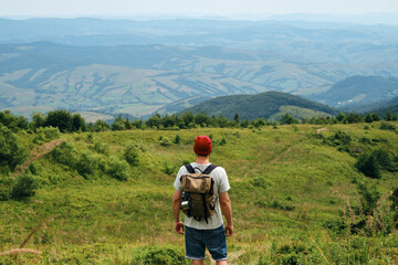 Man enjoy scenics view on valley. Hiking journey on tourist trail. Outdoor adventure. Beautiful nature landscape in mountains. Travel and exploration. Healthy lifestyle, leisure activities