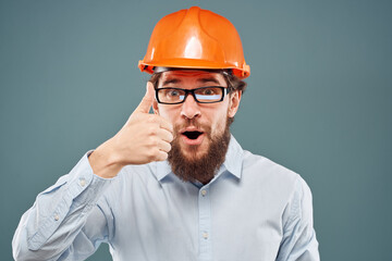 emotional man wearing glasses orange helmet work industry