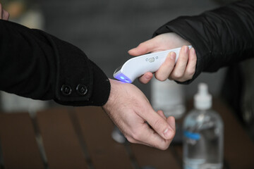 Visitors must go through fever measures using infrared digital thermometer check temperature...