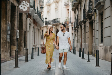 A girl and her boyfriend are walking together in the center of Valencia in Spain