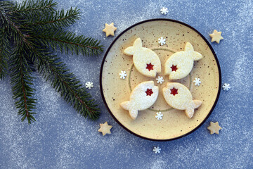 Fish shaped linzer cookies filled with strawberry jam, with romantic festive Christmas decoration
