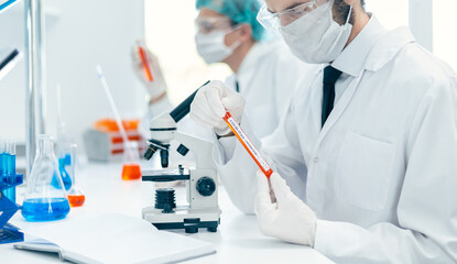 close up. scientist holds a tube with a sample of the new test.