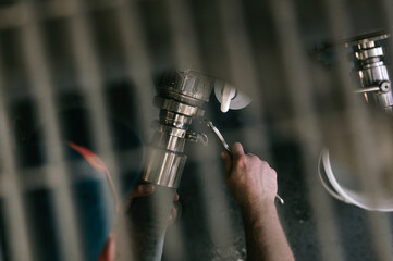Man tightening a valve with a wrench