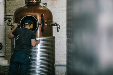 man looking into a vat