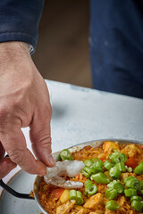 Cooking and making a traditional Spanish Paella. Traditional way of preparing Valencian paella