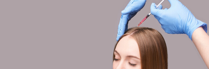 Doctor hands in protective medical gloves. Hair injection. Pretty young woman. Face anti age treatment. Cosmetology clinic. Medical concept. Head rejuvenation. Rich scalp pink filler. Copyspace - obrazy, fototapety, plakaty