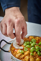 Cooking and making a traditional Spanish Paella. Traditional way of preparing Valencian paella