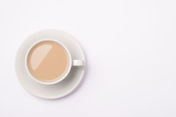 Close up top  above overhead view photo of cup of caramel color fresh tasty beverage in white cup isolated over white background