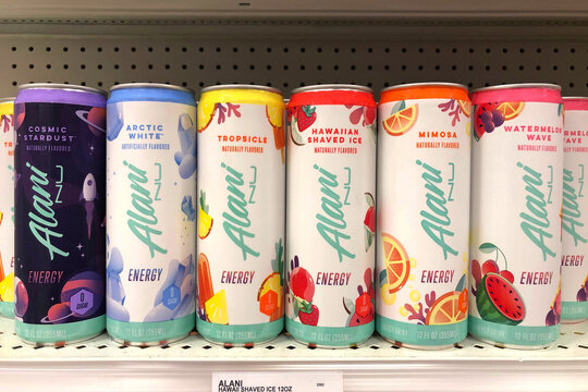 Alameda, CA - Nov 22, 2020: Grocery store shelf with cans of Alani Energy drink in various flavors. Naturally and Artificially flavored.