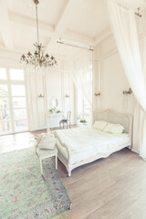 beautiful white bright clean interior bedroom in luxurious baroque style.