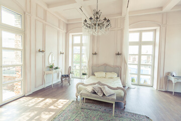 beautiful white bright clean interior bedroom in luxurious baroque style.