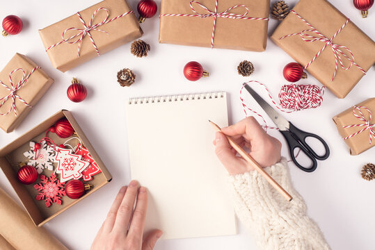 Top above pov overhead close up view photo of female woman writer author hands making notes to open sketch book near newyear accessories