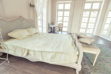 beautiful white bright clean interior bedroom in luxurious baroque style.