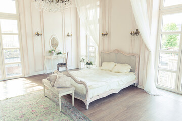 beautiful white bright clean interior bedroom in luxurious baroque style.