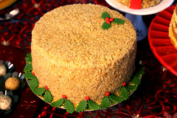 Christmas sweets and cakes. Decorate table with delicious Christmas sweets, chocolate and candys. Santa Claus, bear and others