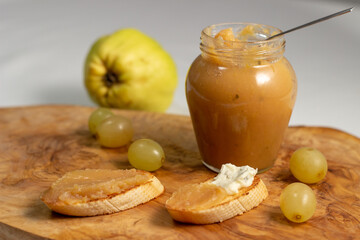 Homemade quince jam. Slices of bread with cheese and quince jam
