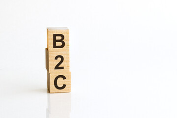 B2C - acronym from wooden blocks with letters, Business-to-consumer. White background.