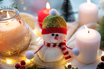 Winter Christmas holidays background with candles; christmas light; Cup of cocoa with marshmallow...