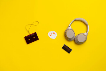 analog versus digital music, headphones and vinyl cassette flat lay