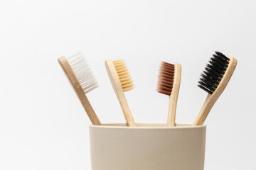 Multicolored bamboo toothbrushes on white background