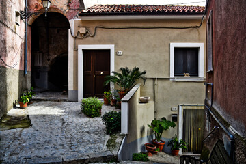 Fototapeta na wymiar A narrow street among the old houses of Ciorlano, an old town in Caserta province, Italy.