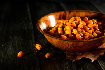 Seabuckthorn in a bowl on a wooden table