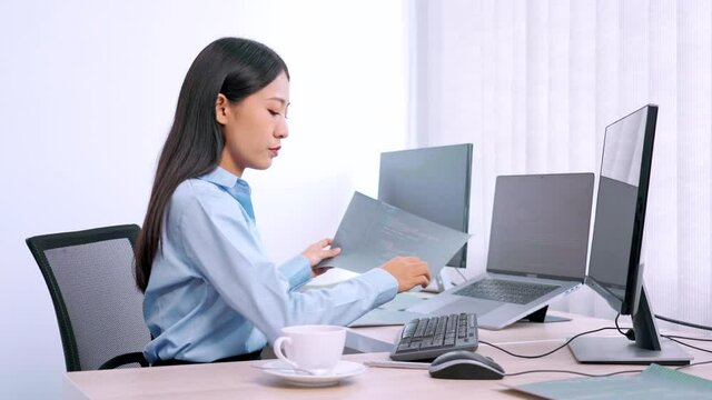 Asian woman programmer typing source code with computer pc for Developing program or application in her office