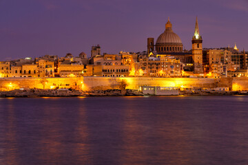 Naklejka na ściany i meble Sunset over the citadella of Valletta, capital city of Malta.