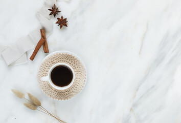 coffee cup Christmas corner border, with anise stars and cinnamon sticks on marble surface with...