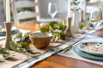 Beautiful holiday table setting in greens and gold