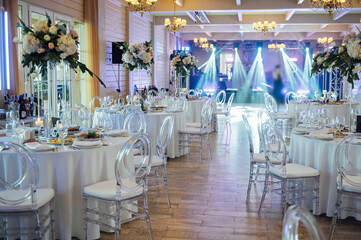 A beautiful vase of flowers on a table in a luxury restaurant. Wedding decorations