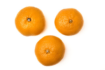 Three juicy tangerines lined up in a triangle. Isolated on a white background. Top view.