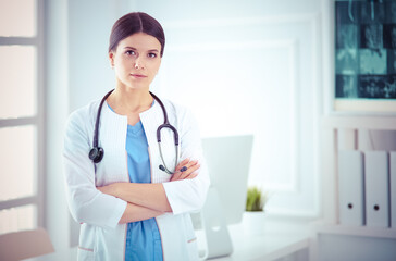 Young smiling female doctor with stethoscope at doctor's office