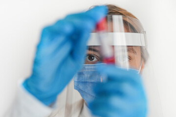 Female doctor wearing protective equipment working - closeup up eye - coronavirus health concept
