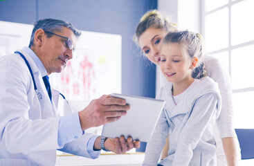 Fototapeta premium Portrait of a cute little girl and her doctor at hospital
