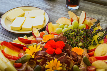 Fototapeta na wymiar Cheese and fruit assortment on a plate or on a table.
